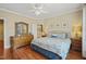 Spacious bedroom features hardwood floors, dresser with mirror, and queen bed with blue bedding at 8308 Buck Crossing Dr, Durham, NC 27713