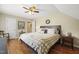 Comfortable bedroom features neutral decor, ceiling fan, hardwood floors, and natural light at 8308 Buck Crossing Dr, Durham, NC 27713