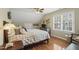 Guest bedroom features natural light, hardwood floors, neutral decor, and a ceiling fan at 8308 Buck Crossing Dr, Durham, NC 27713