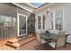 Outdoor deck features dining table with seating, screened door to porch, and backyard access at 8308 Buck Crossing Dr, Durham, NC 27713