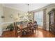 Dining room with hardwood floors, a chandelier, and large windows at 8308 Buck Crossing Dr, Durham, NC 27713