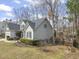 Landscaped side yard of a two-story home with a peek of the fenced in backyard at 8308 Buck Crossing Dr, Durham, NC 27713