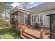Home features a spacious deck, screened porch access, and a manicured lawn at 8308 Buck Crossing Dr, Durham, NC 27713