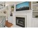 Elegant fireplace with built-in shelving and a large television at 8308 Buck Crossing Dr, Durham, NC 27713