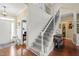 Elegant foyer with staircase, hardwood floors, and paneled accent wall at 8308 Buck Crossing Dr, Durham, NC 27713