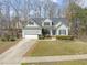 Beautiful two-story home with a garage, manicured lawn, and inviting front entrance at 8308 Buck Crossing Dr, Durham, NC 27713