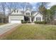 Charming two-story home with a well-manicured lawn, garage, and inviting entryway at 8308 Buck Crossing Dr, Durham, NC 27713