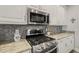 Close up of the kitchen shows stainless steel appliances and granite countertops at 8308 Buck Crossing Dr, Durham, NC 27713