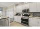 Bright kitchen features granite countertops, stainless steel appliances, and stylish backsplash at 8308 Buck Crossing Dr, Durham, NC 27713