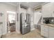 Stainless steel refrigerator and adjacent breakfast area as seen from open concept kitchen at 8308 Buck Crossing Dr, Durham, NC 27713