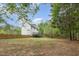 Expansive backyard showcasing lush greenery, privacy fence, and a spacious deck ideal for outdoor gatherings at 9332 Carley Cir, Garner, NC 27529