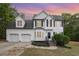 Charming two-story home featuring a manicured lawn, a bay window, and a two-car garage at 9332 Carley Cir, Garner, NC 27529