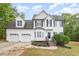 Charming two-story home featuring a manicured lawn, a bay window, and a two-car garage at 9332 Carley Cir, Garner, NC 27529