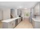 Modern kitchen features gray cabinets, stainless appliances, and an island with quartz counters at 9332 Carley Cir, Garner, NC 27529