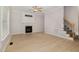 Bright living room boasts fresh paint, hardwood floors, a fireplace, and staircase at 9332 Carley Cir, Garner, NC 27529