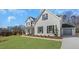 A charming white brick home with a well-manicured lawn, showcasing its appealing curb appeal and design at 0009 Tallulah Loop Ln, Cedar Grove, NC 27231