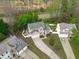 An aerial view of a well-maintained home with a long driveway, fenced yard, and mature trees at 1008 Double Spring Ct, Apex, NC 27502