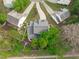 An aerial view displaying a backyard oasis featuring mature trees and a cozy patio space at 1008 Double Spring Ct, Apex, NC 27502
