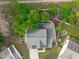 An aerial view of the home showcases landscaping, the driveway, and a patio with outdoor furniture at 1008 Double Spring Ct, Apex, NC 27502