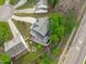 An aerial view showcasing the backyard with a patio and fire pit area nestled among mature trees at 1008 Double Spring Ct, Apex, NC 27502