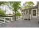 Back deck with a green bench, beige siding, and white trim perfect for relaxing and enjoying the outdoors at 1008 Double Spring Ct, Apex, NC 27502