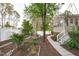 Backyard with a beautiful garden, a well-maintained lawn, and a sidewalk at 1008 Double Spring Ct, Apex, NC 27502