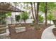 Serene backyard with garden, shady trees, and cozy bench seating for relaxation and enjoyment at 1008 Double Spring Ct, Apex, NC 27502