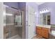 Lovely bathroom featuring a glass shower, a vanity with white cabinets, and lilac colored walls at 1008 Double Spring Ct, Apex, NC 27502