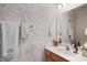 Elegant powder room featuring decorative wallpaper and a classic vanity sink at 1008 Double Spring Ct, Apex, NC 27502