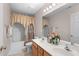 Double vanity bathroom with warm-toned cabinets and decorative accents at 1008 Double Spring Ct, Apex, NC 27502