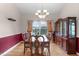 Classic dining room with a large china cabinet, ample light and hardwood floors at 1008 Double Spring Ct, Apex, NC 27502
