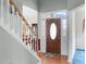 Bright entryway with wood floors, a staircase and front door with transom window at 1008 Double Spring Ct, Apex, NC 27502