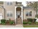 Charming home with a beautiful stone stairway leading to an arched front entryway, surrounded by lovely landscaping at 1008 Double Spring Ct, Apex, NC 27502
