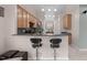 Kitchen featuring dark countertops, bar seating and cabinets with views to dining area at 1008 Double Spring Ct, Apex, NC 27502