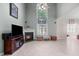 Spacious living room featuring a fireplace, cathedral ceilings, and lots of natural light at 1008 Double Spring Ct, Apex, NC 27502