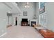 Bright living room with fireplace, high ceilings, large windows and modern decor at 1008 Double Spring Ct, Apex, NC 27502
