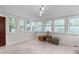 Bright sunroom with tiled floor, many windows, and light-colored walls at 1008 Double Spring Ct, Apex, NC 27502