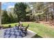 Landscaped backyard with a patio seating area at 103 Woolard Way, Apex, NC 27502