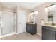 Well-lit bathroom with a double vanity, granite countertops, a shower and tile floors at 103 Woolard Way, Apex, NC 27502