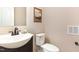 Cozy bathroom with a pedestal sink, tiled floors, and neutral colored walls at 103 Woolard Way, Apex, NC 27502