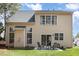 Exterior view of the home with a patio and sliding glass doors at 103 Woolard Way, Apex, NC 27502