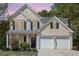 Charming two-story home with a two-car garage and landscaped front yard at 103 Woolard Way, Apex, NC 27502