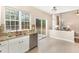 Bright kitchen with stainless steel appliances, granite countertops and a large window with a view of the trees at 103 Woolard Way, Apex, NC 27502