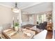 Spacious living room with wood floors, neutral walls, and an open floor plan at 103 Woolard Way, Apex, NC 27502