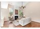 Living room with a fireplace, high ceilings, large windows and hardwood floors providing a cozy and inviting space at 103 Woolard Way, Apex, NC 27502