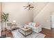 Comfortable living room featuring vaulted ceilings, a ceiling fan, hardwood floors and a decorative rug at 103 Woolard Way, Apex, NC 27502