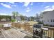 Spacious back deck with grill, seating, and neighborhood views, perfect for entertaining at 105 Smoky Emerald Way, Holly Springs, NC 27540