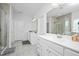 Modern bathroom with double vanities, tile flooring, and a glass-enclosed shower at 105 Smoky Emerald Way, Holly Springs, NC 27540