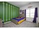 Bedroom featuring a sports themed wall design, neutral carpet, and natural light from the window at 105 Smoky Emerald Way, Holly Springs, NC 27540