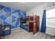 Bedroom with a unique accent wall, bunk beds with attached storage, and natural light from the window at 105 Smoky Emerald Way, Holly Springs, NC 27540
